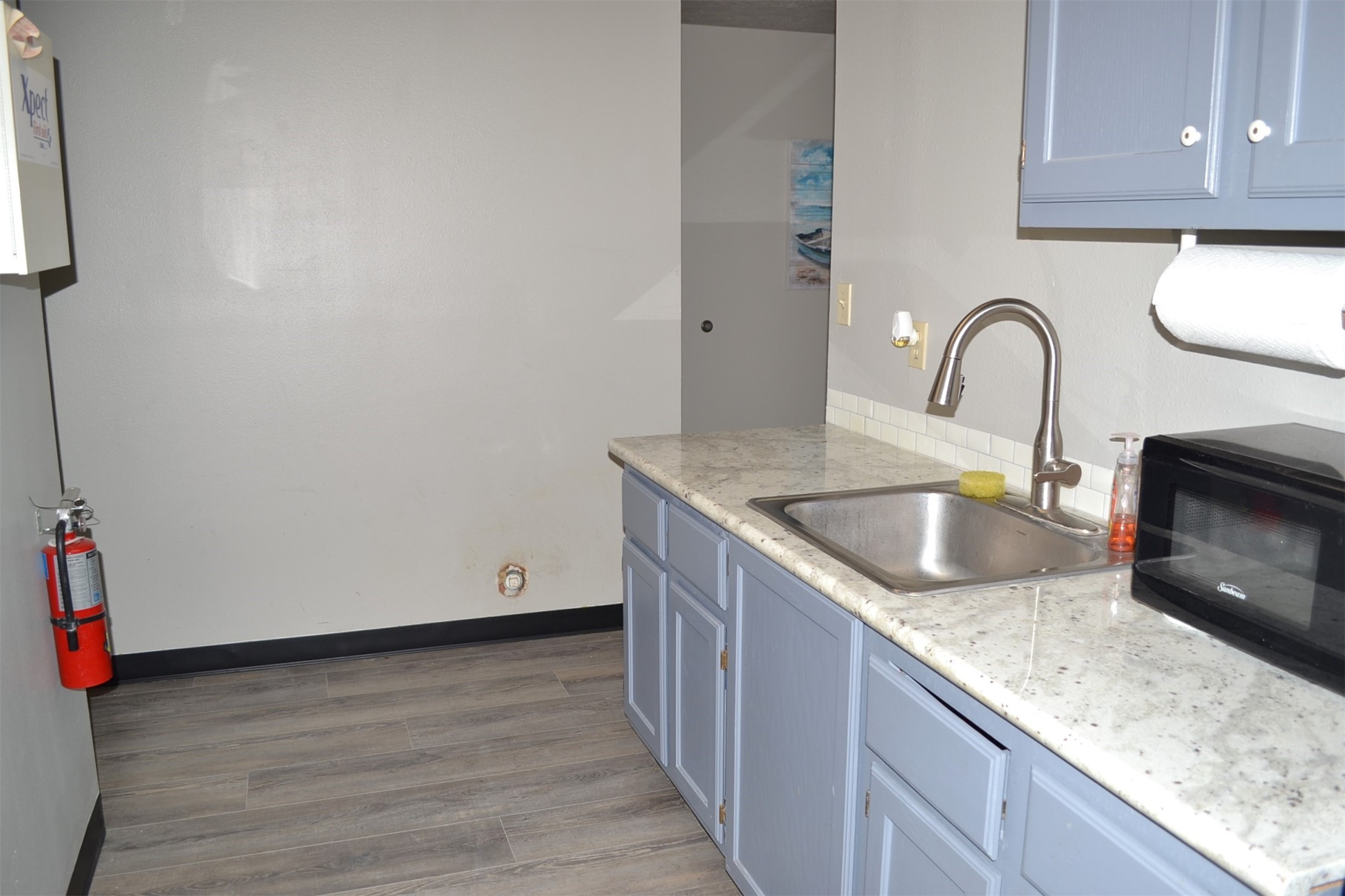 12122 Knigge Cemetery Road Cypress, TX 77429 - Photo 12 of 48 a view of kitchen with granite countertop stainless steel appliances sink and wooden floor
