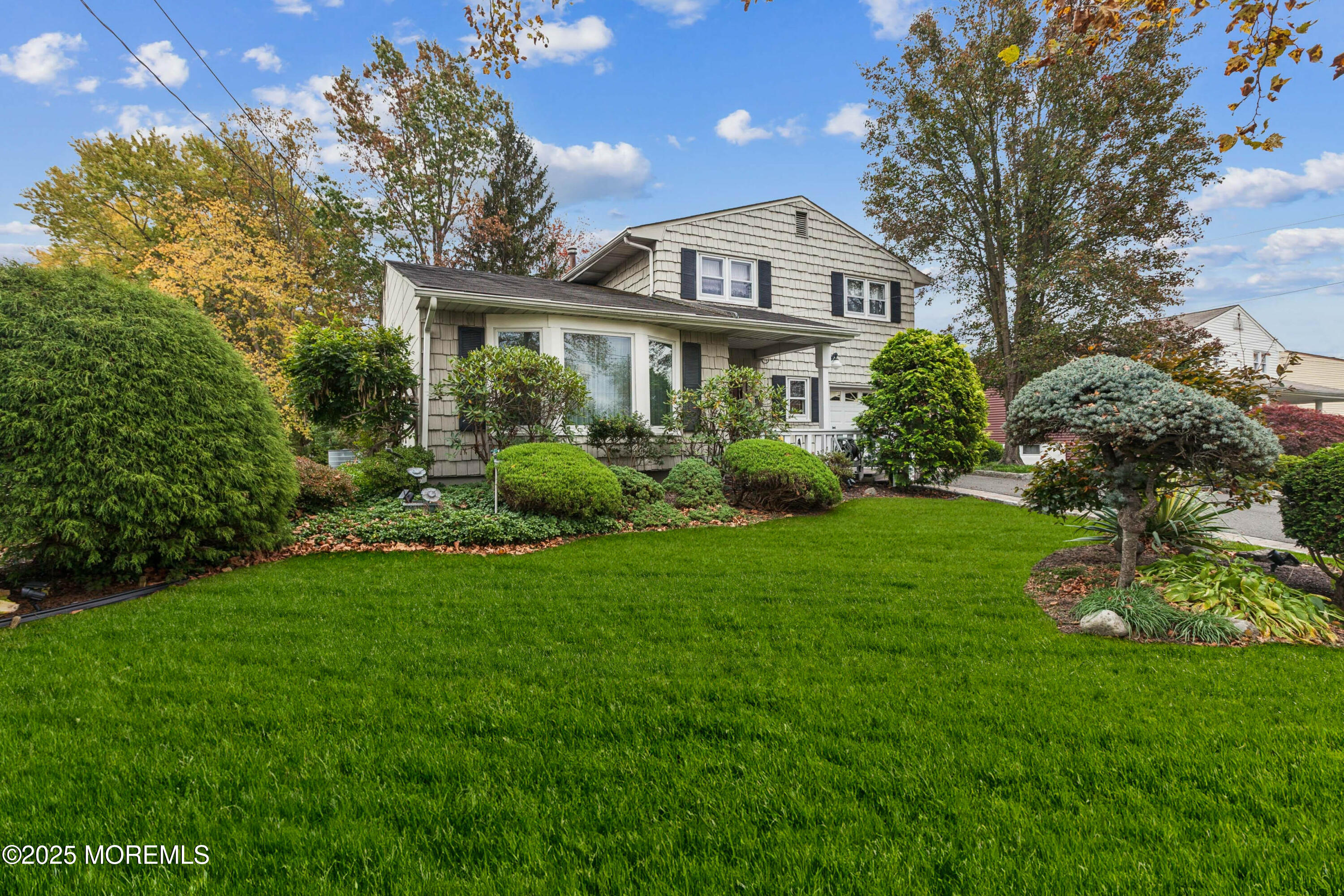 a front view of a house with garden