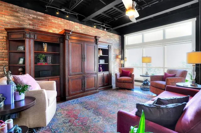 a living room with furniture and a potted plant