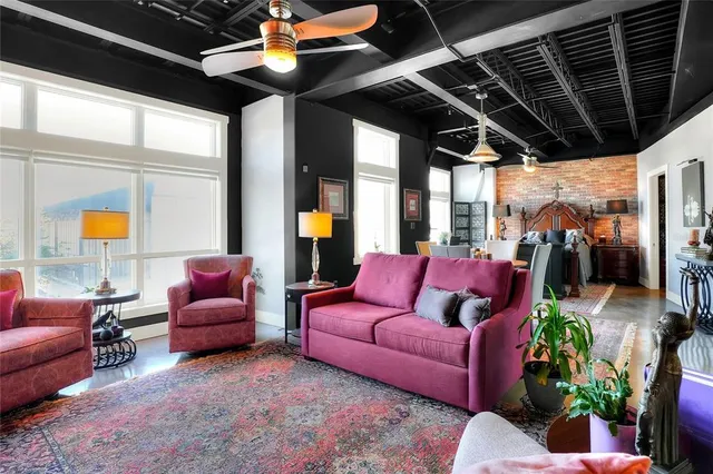 a living room with furniture and a large window