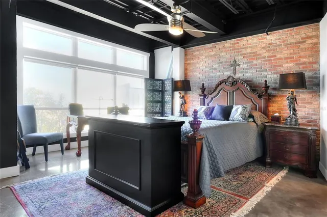 a dining room with furniture and a floor to ceiling window