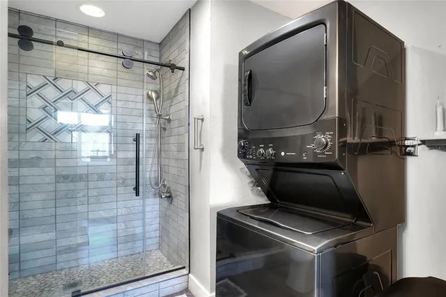 a bathroom with a shower and mirror