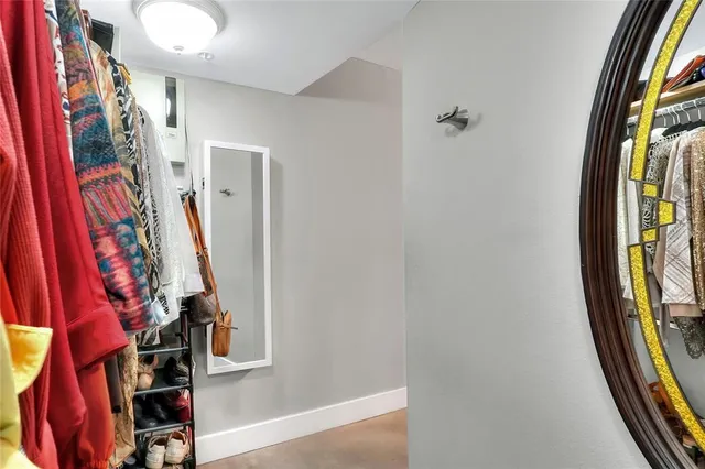 a view of a hallway with front door and mirror