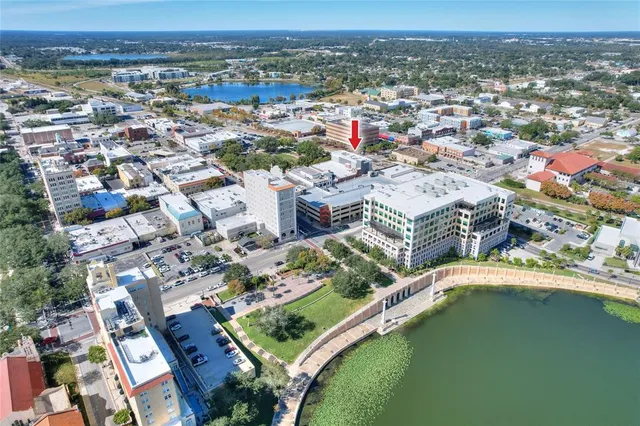 an aerial view of a house with a lake