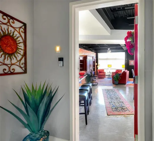a living room with furniture plant and a window