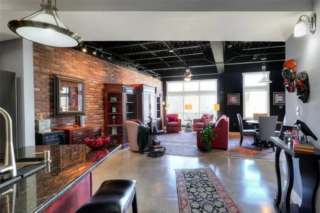 a living room with lots of furniture and a chandelier