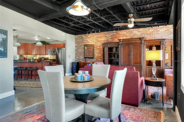 a dining room with furniture and a chandelier