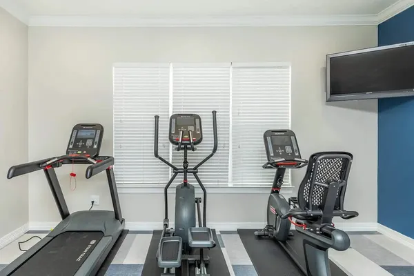 a room with gym equipment and windows