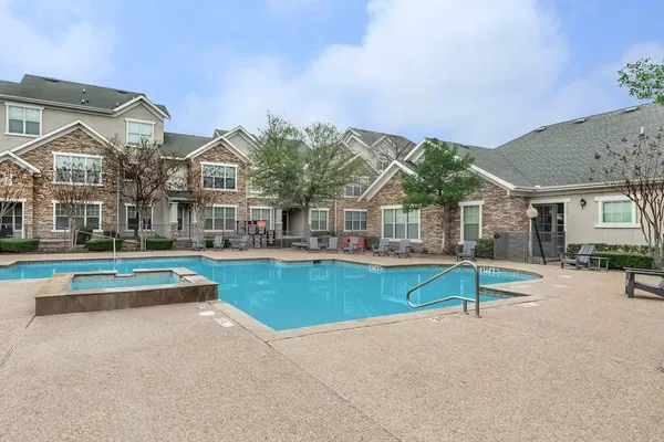 an outdoor space with swimming pool and furniture