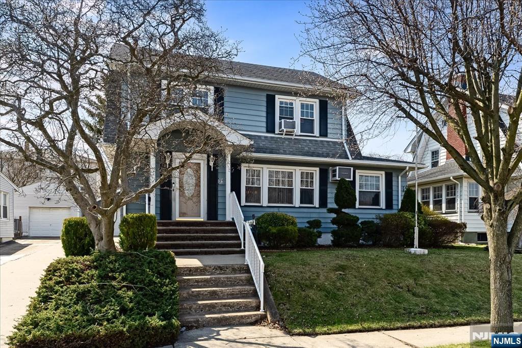 52 Manner Avenue Garfield, NJ 07026 - Photo 1 of 23 a front view of a house with a garden