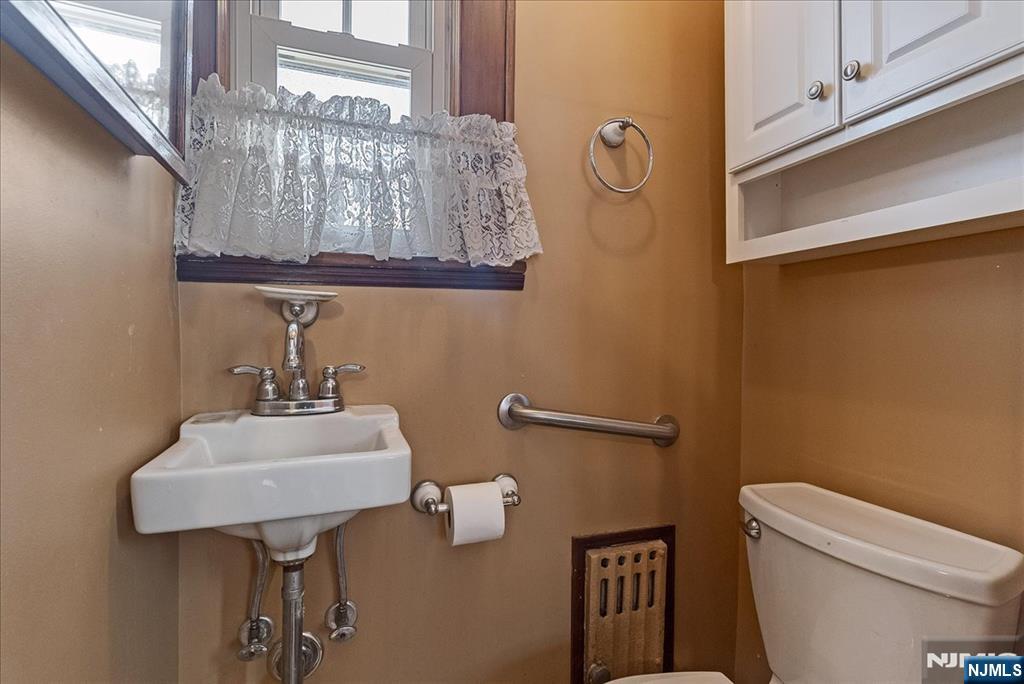 52 Manner Avenue Garfield, NJ 07026 - Photo 13 of 23 a bathroom with a sink a toilet and a mirror