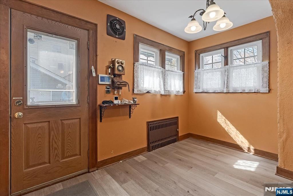 52 Manner Avenue Garfield, NJ 07026 - Photo 14 of 23 an empty room with wooden floor cabinet and windows