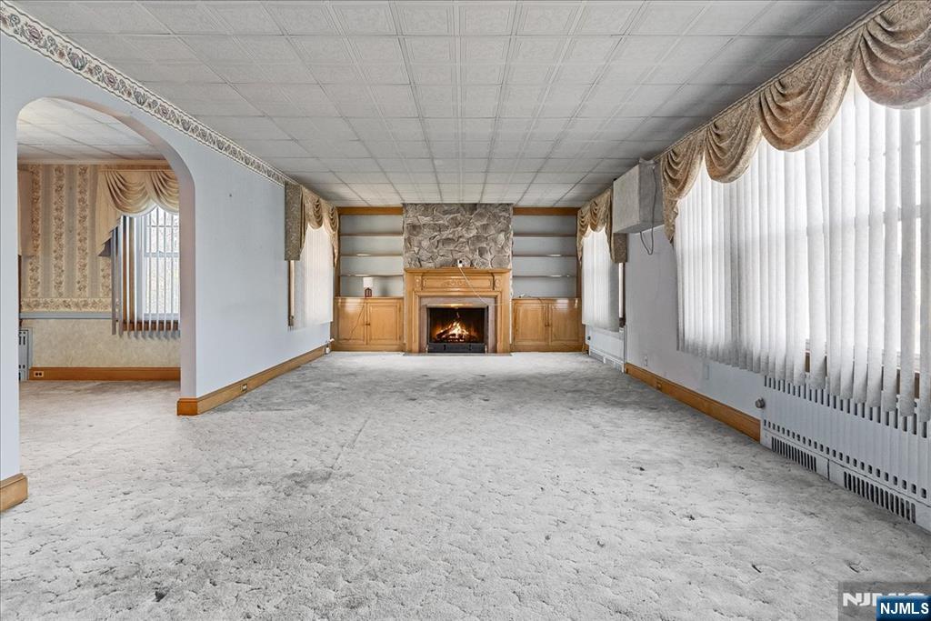 52 Manner Avenue Garfield, NJ 07026 - Photo 4 of 23 a view of empty room with fireplace and windows