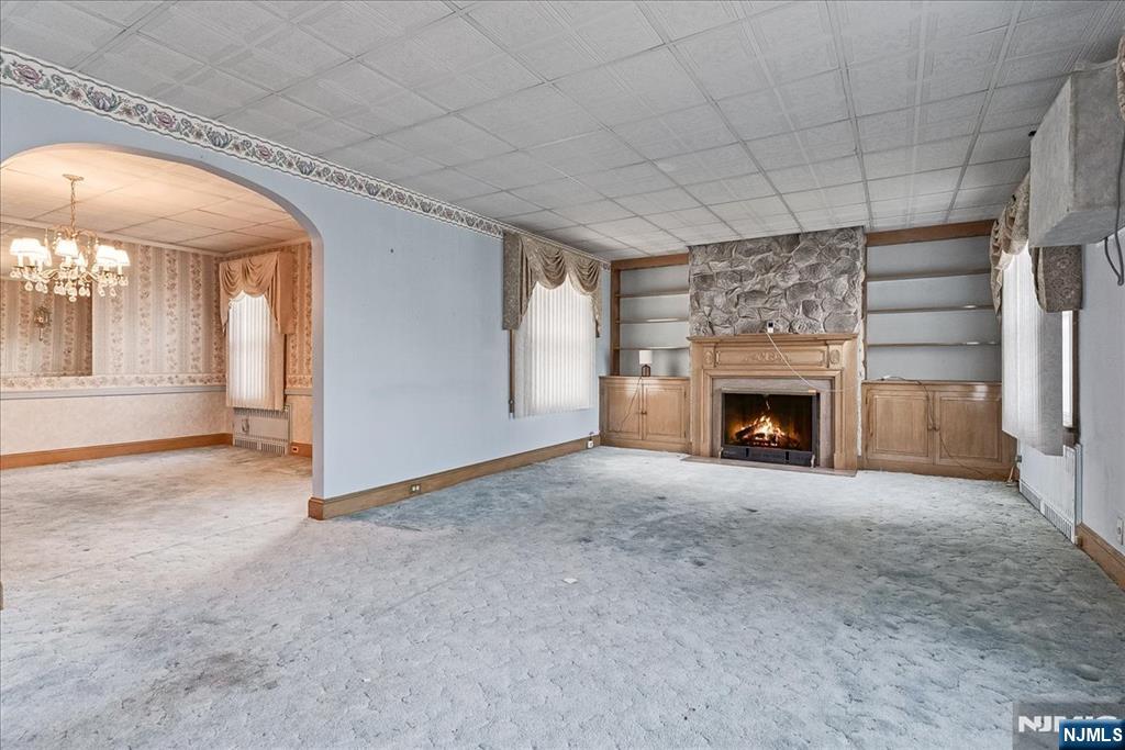 52 Manner Avenue Garfield, NJ 07026 - Photo 6 of 23 an empty room with a fireplace and fan
