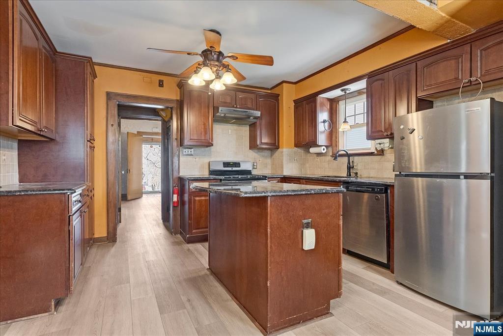 52 Manner Avenue Garfield, NJ 07026 - Photo 10 of 23 a kitchen with stainless steel appliances granite countertop a refrigerator a sink dishwasher a stove top oven a refrigerator and cabinets