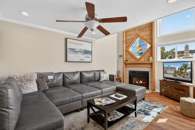 a living room with furniture a flat screen tv and a fireplace