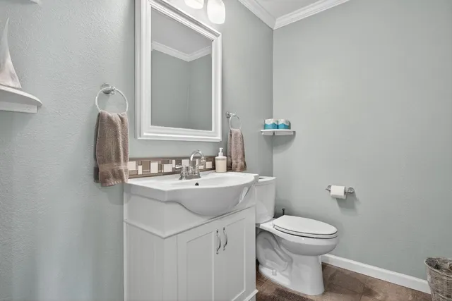 a bathroom with a sink toilet and mirror