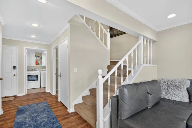 a view of entryway and hall with wooden floor