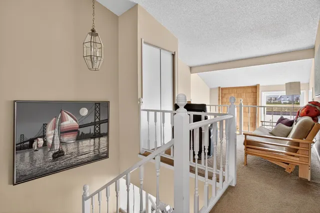 a view of a livingroom with furniture and staircase