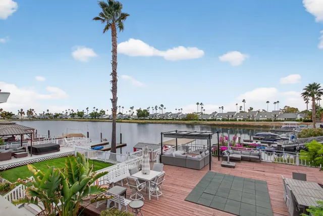 a view of a terrace with furniture and a lake view