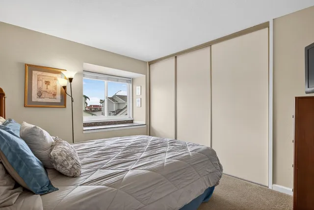 a bedroom with a bed and glass window