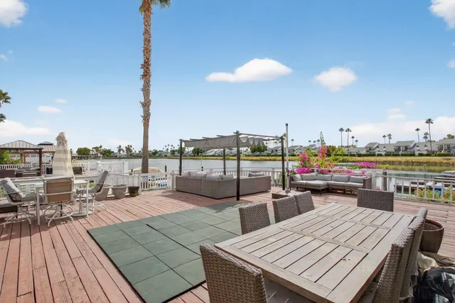 a view of a roof deck with table and chairs