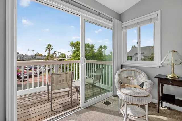 a view of a balcony with chair and glass door