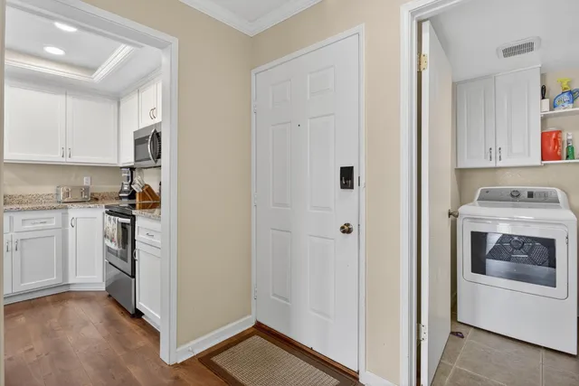 a kitchen with white cabinets and white appliances