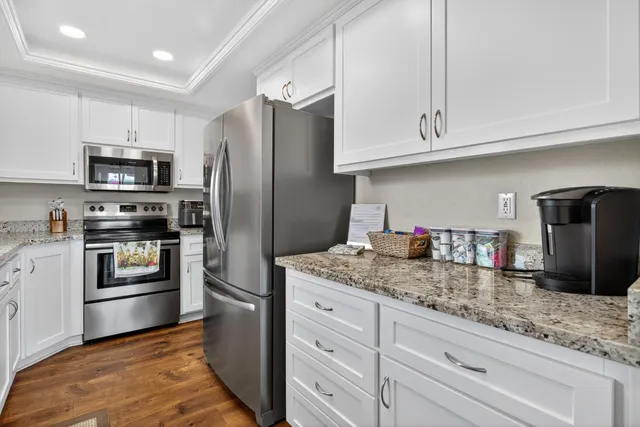 a kitchen with appliances a sink and cabinets