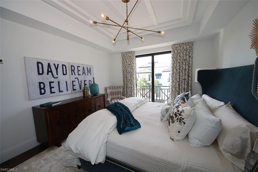 1035 3rd Avenue South, Unit 411 Naples, FL 34102 - Photo 16 of 49 a bedroom with furniture and a window