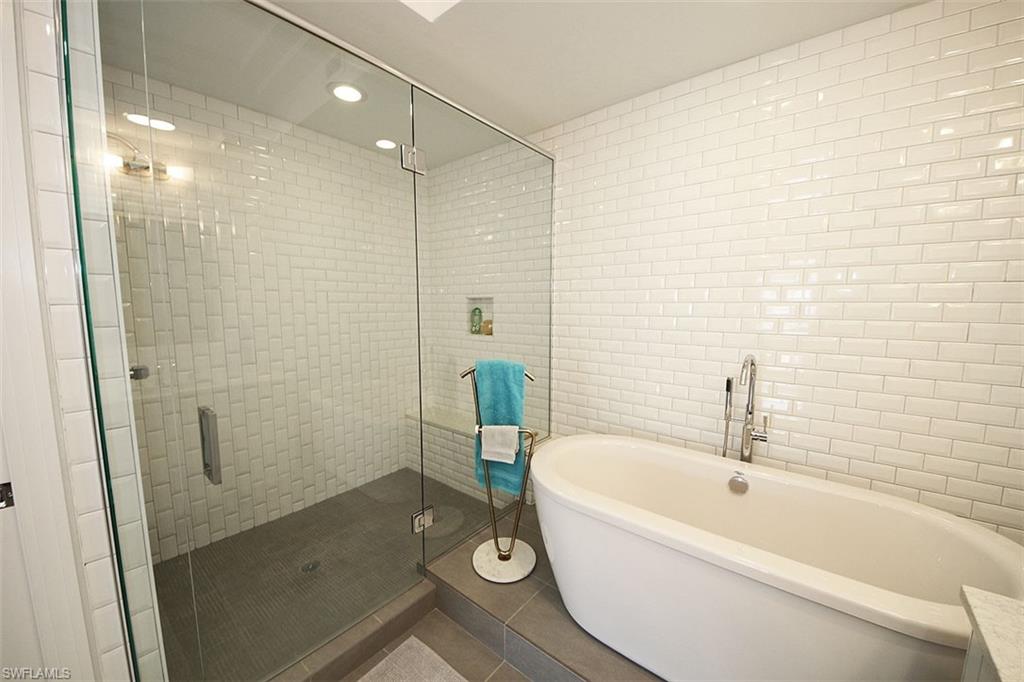 1035 3rd Avenue South, Unit 411 Naples, FL 34102 - Photo 18 of 49 a bathroom with a bathtub and a shower