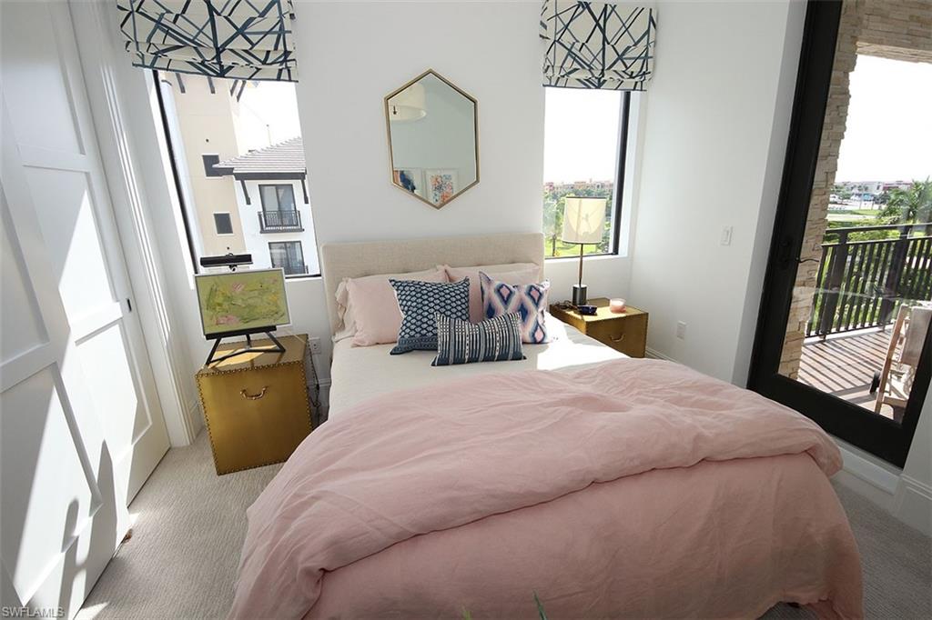 1035 3rd Avenue South, Unit 411 Naples, FL 34102 - Photo 20 of 49 a bedroom with a bed and a window