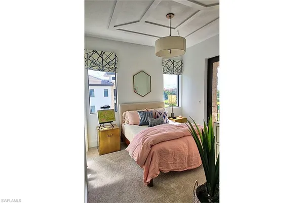 a bedroom with a bed potted plant with the mirror
