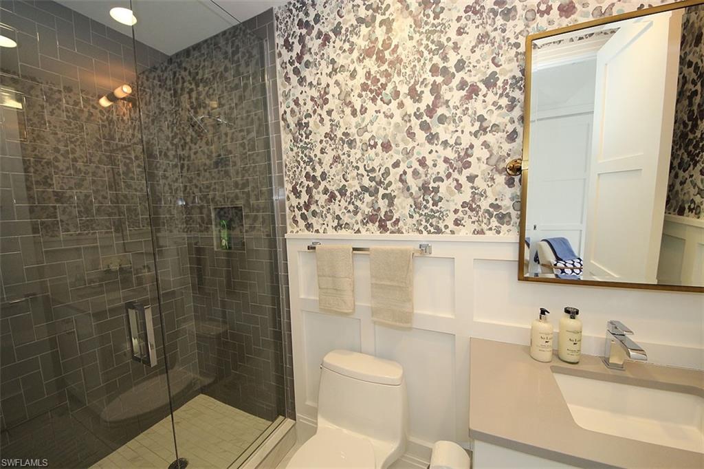 1035 3rd Avenue South, Unit 411 Naples, FL 34102 - Photo 24 of 49 a bathroom with a shower toilet and a sink