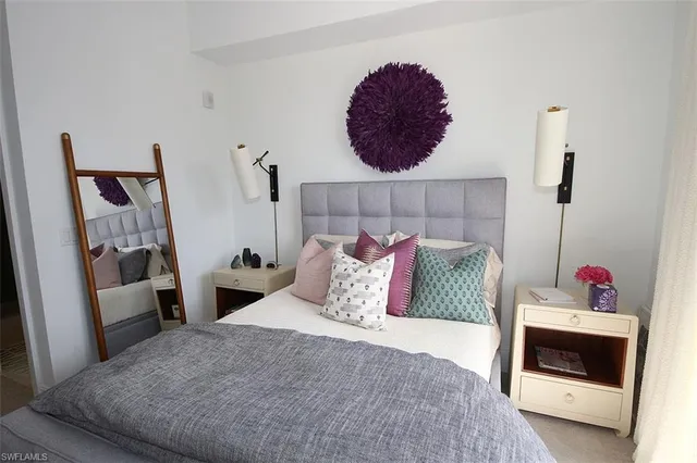 a bedroom with a bed and a mirror