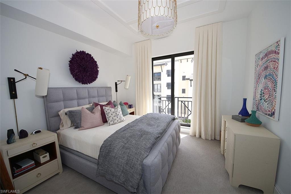 1035 3rd Avenue South, Unit 411 Naples, FL 34102 - Photo 26 of 49 a bedroom with a bed and a flat tv screen on the dresser