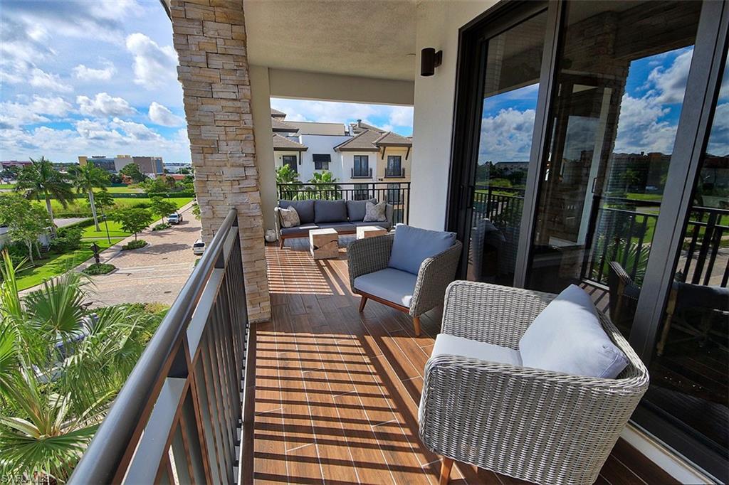 1035 3rd Avenue South, Unit 411 Naples, FL 34102 - Photo 28 of 49 a balcony with furniture