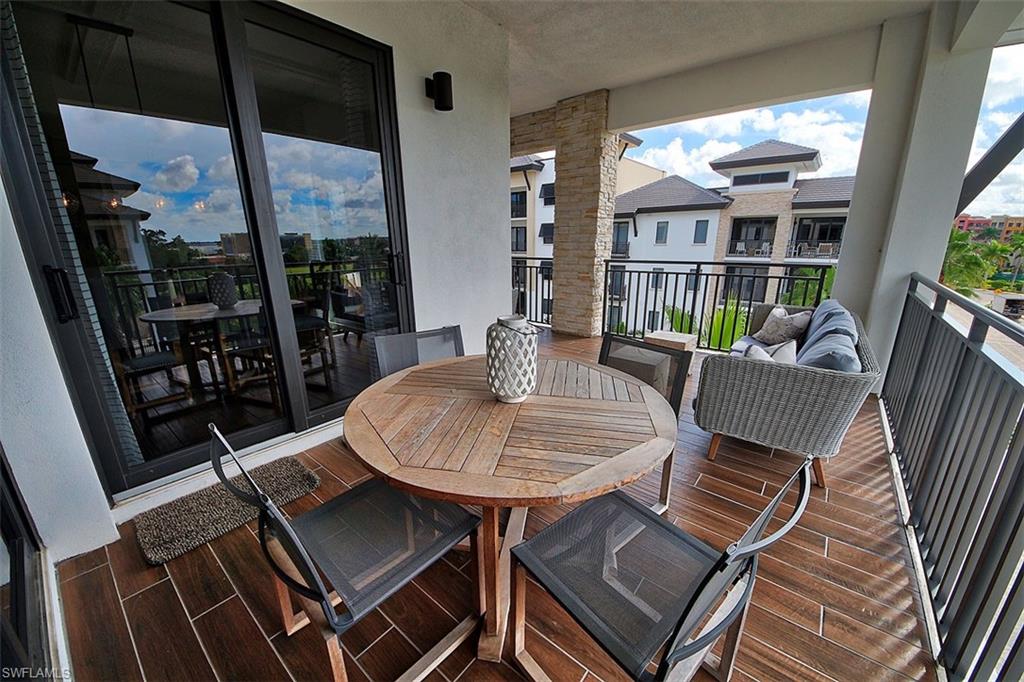 1035 3rd Avenue South, Unit 411 Naples, FL 34102 - Photo 29 of 49 a view of a balcony dining area with furniture