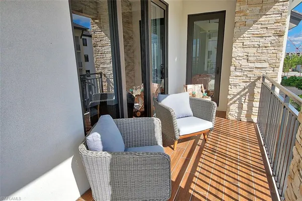 a view of a balcony dining area with furniture