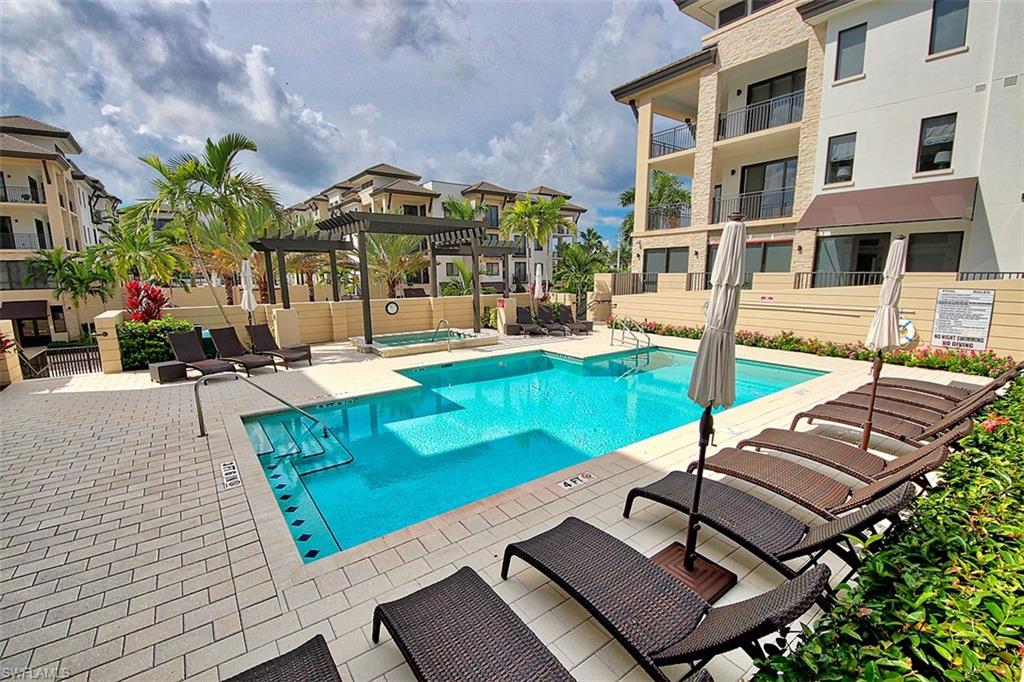 1035 3rd Avenue South, Unit 411 Naples, FL 34102 - Photo 36 of 49 a view of a house with swimming pool and sitting area