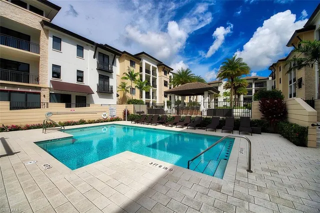 a view of a house with swimming pool and sitting area