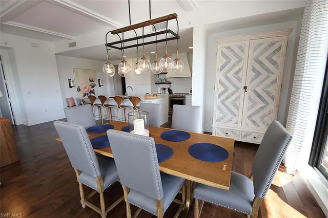 a view of a dining room with furniture and chandelier