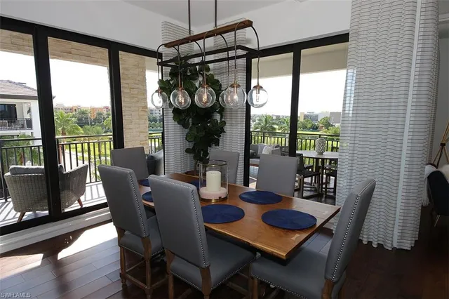 a dining room with furniture a chandelier and wooden floor