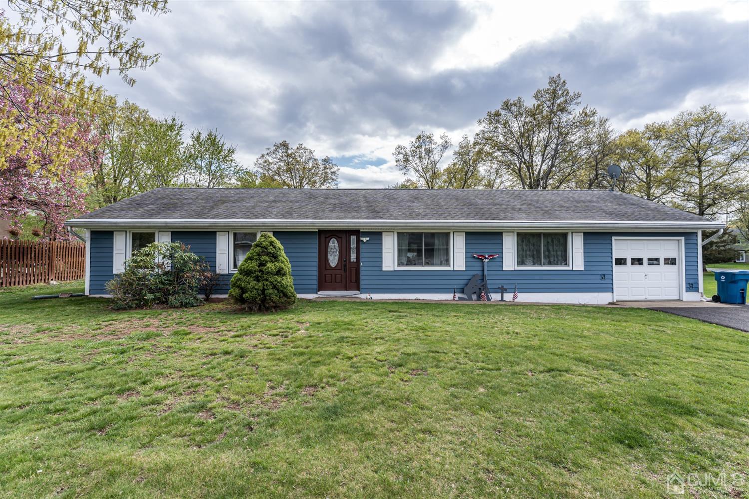 a front view of a house with a garden