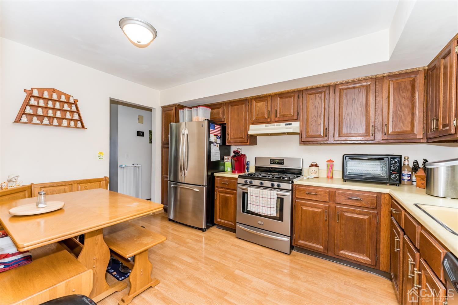 88 Stratton Street South Piscataway, NJ 08854 - Photo 7 of 22 a kitchen with stainless steel appliances granite countertop a stove refrigerator sink and cabinets