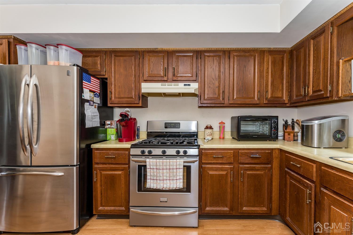 88 Stratton Street South Piscataway, NJ 08854 - Photo 9 of 22 a kitchen with stainless steel appliances granite countertop a refrigerator stove and cabinets