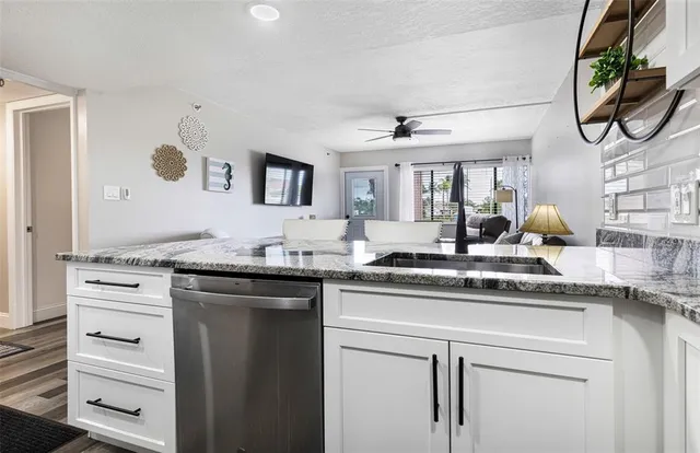 a kitchen with stainless steel appliances granite countertop a sink and cabinets
