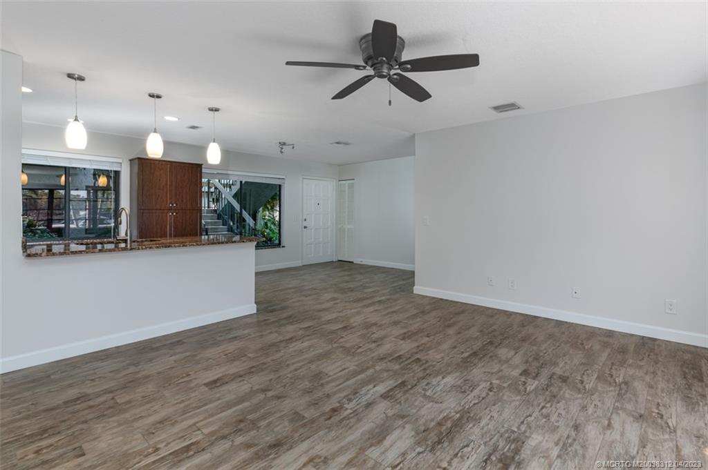 800 Northwest Fork Road, Unit 86 Stuart, FL 34994 - Photo 11 of 40 a view of a kitchen with a sink and wooden floor