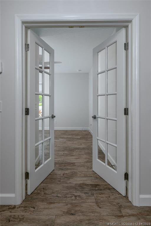 800 Northwest Fork Road, Unit 86 Stuart, FL 34994 - Photo 15 of 40 an empty room with wooden floor cabinet and windows