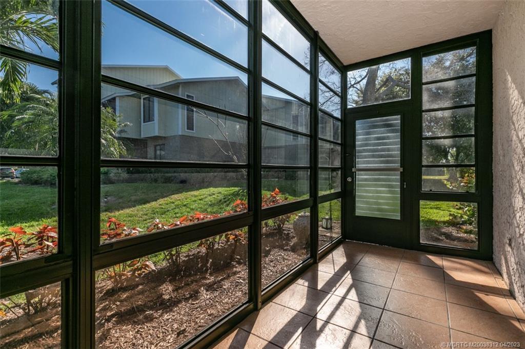 800 Northwest Fork Road, Unit 86 Stuart, FL 34994 - Photo 23 of 40 a view of a glass door with a balcony from a window